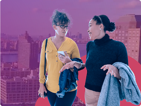 Photo of two women walking and talking. They are composited on top of a purple-hued background photo of a skyline.