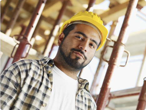 Close up photo of a man in a hard hat looking at the camera